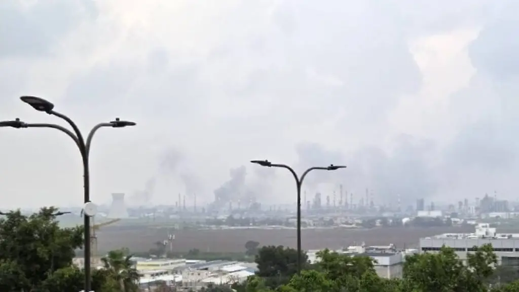 260319-HAIFA-March-19-2026-Xinhua-This-photo-released-by-Israeli-media-shows-smoke-rising-from-oil-refineries-in-Haifa-northern-Israel-March-19-2026-A-missile-launched-from-Iran-on-Thursday-hit-the-oil-refineries-in-Haifa-northern-Israel-state-owned-Kan-TV-News-reported