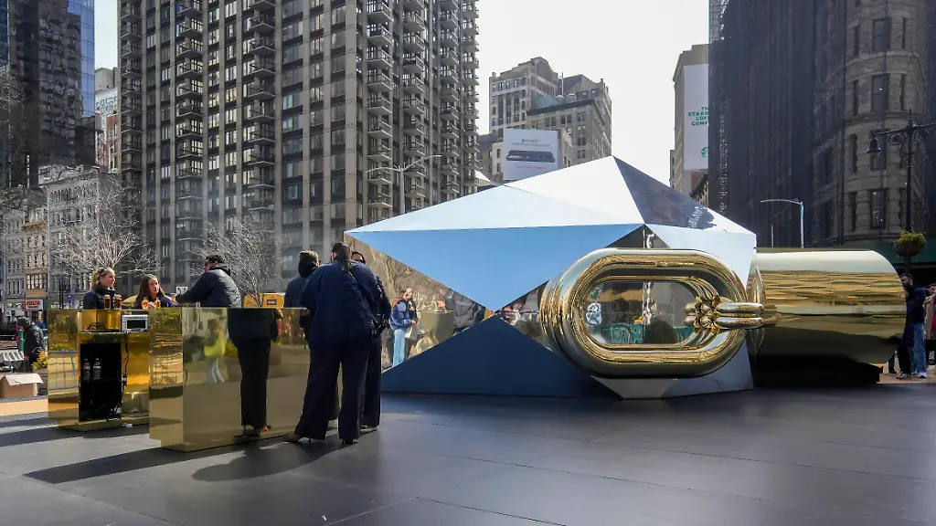 Visitors-line-up-to-enter-a-giant-over-turned-perfume-bottle-at-the-brand-activation-for-Rabanne-Million-Gold-for-Her-fragrance-in-Flatiron-Plaza-in-New-York-on-Thursday-March-13-2025-Rabanne-formerly-Paco-Rabanne-is-a-luxury-brand-owned-by-the-Spanish-family-owned-business-the-Puig-Group-APhoto-by-Richard-B