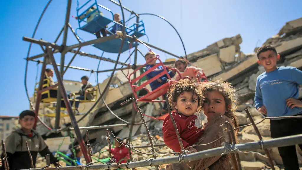 GAZA-CITY-GAZA-MARCH-22-Displaced-Palestinian-children-are-having-fun-on-swings-set-up-amidst-the-rubble-of-buildings-and-makeshift-tents-on-the-third-day-of-Eid-al-Fitr-in-Tel-al-Hawa-neighborhood-of-Gaza-City-Gaza-on-March-22-2026-Saeed-M-M-T