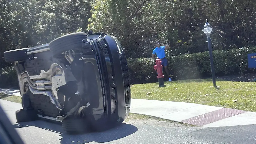 Golfer-Tiger-Woods-stands-by-his-overturned-vehicle-in-Jupiter-Island-Fla-on-Friday-March-27-2026