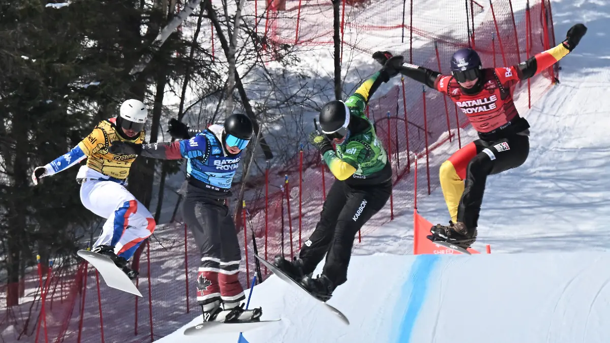 March-28-2026-Beaupre-Pq-Canada-Fourth-place-finish-Julien-Thomas-from-the-left-of-France-third-place-Evan-Bichon-of-Mackenzie-British-Columbia-race-winner-Adam-Lambert-of-Australia-and-second-place-Leon-Ulbricht-of-Germany-leap-to-the-finish-Saturday-March-28-2026-at-the-FIS-snowboard-cross-world-cup-event-at-Mont-Sainte-Anne-resort-in-Beaupre-Quebec