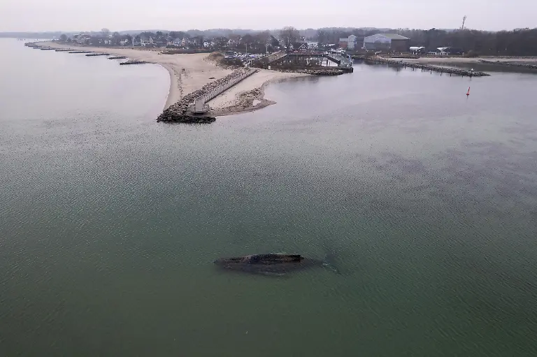 This-aerial-view-taken-on-March-24-2026-and-handed-out-by-Sea-Shepherd-Deutschland-shows-a-standed-humpback-whale-off-the-Baltic-Sea-coast-of-Timmendorfer-Strand-near-Luebeck-northern-Germany-The-health-of-the-animal-is-deteriorating-conservationists-said-as-efforts-to-free-the-animal-continued-The-10-metre-33-foot-long-whale-was-first-spotted-stuck-in-shallow-water-close-to-Niendorf-near-the-city-of-Luebeck-early-on-Monday-March-23-2026-Rescuers-have-been-trying-since-to-get-it-back-into-deeper-water-so-far-without-success