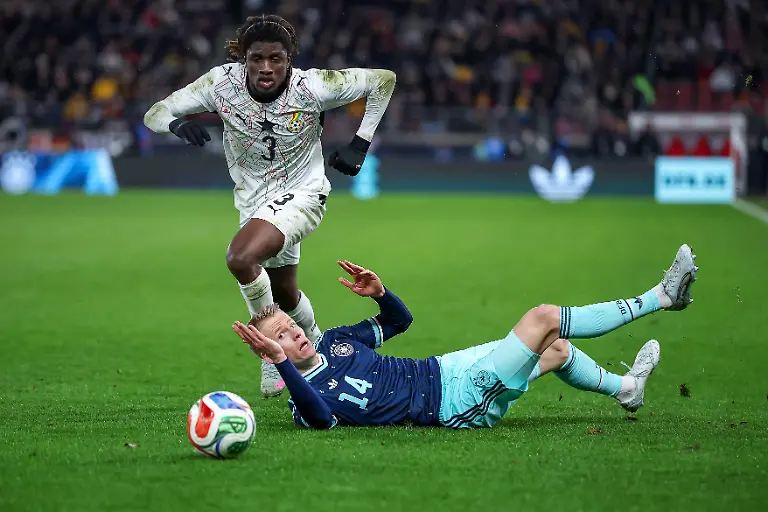 30-03-2026-Fussball-Laenderspiel-Deutschland-Ghana-MHP-Arena-Stuttgart-Saison-2025-2026-Caleb-Yirenkyi-Ghana-3-im-Zweikampf-gegen-Chris-Fuehrich-GER-14-DFB-regulations-prohibit-any-use-of-photographs-as-image-sequences-and-or-quasi-video
