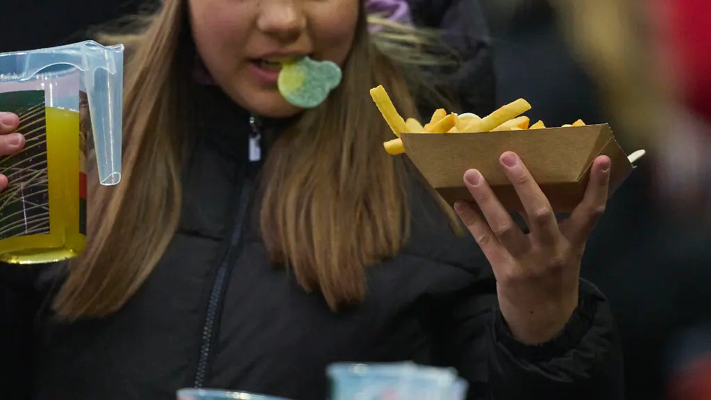 Spectator-with-food-and-beer-in-the-match-FC-AUGSBURG-VFL-WOLFSBURG-1-0-on-Mar-15-2025-in-Augsburg-Germany-Season-2024-2025-1-Bundesliga-FCA-matchday-26-26