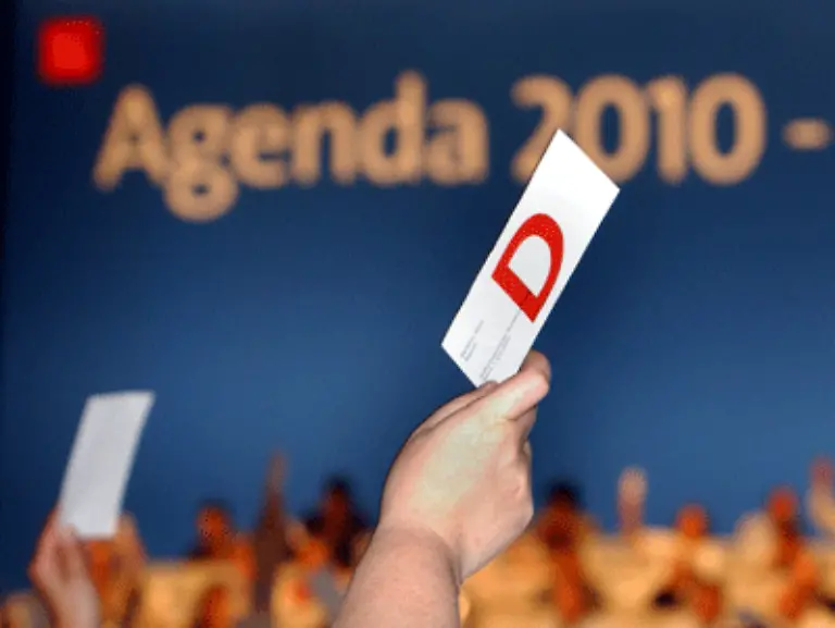 Die-Delegierten-plaedieren-mit-grosser-Mehrheit-fuer-Schroeders-Agenda-2010-Doch-die-Zustimmung-kann-nicht-verdecken-dass-das-Reformwerk-in-Teilen-der-SPD-auf-erheblichen-Widerstand-stoesst-Die-Kritik-daran-soll-nicht-verstummen