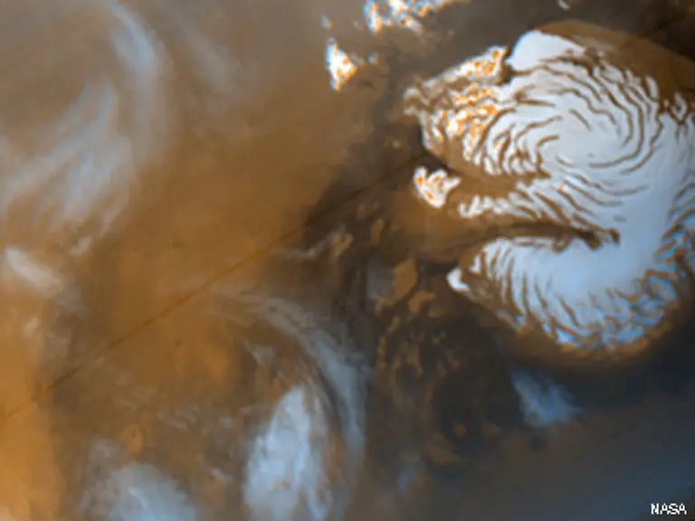 Er-hat-eine-sehr-duenne-Atmosphaere-die-zu-95-aus-Kohlendioxid-besteht-Daneben-kommen-noch-2-7-Stickstoff-1-6-Argon-geringe-Anteile-an-Sauerstoff-und-Kohlenmonoxid-sowie-Spuren-von-Wasserdampf-und-anderen-Verbindungen-oder-Elementen-vor