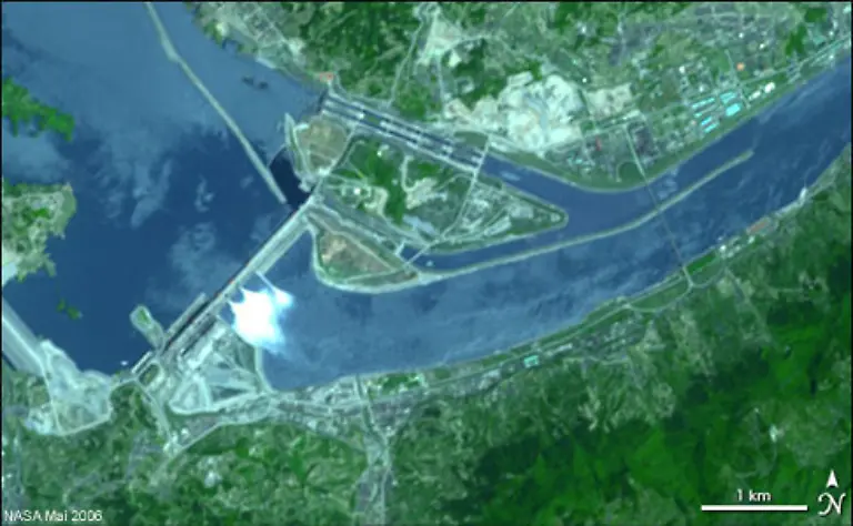 Das-Drei-Schluchten-Projekt-dient-der-Flutkontrolle-und-Energiegewinnung-Auf-Satellitenaufnahmen-sind-die-Dammanlagen-deutlich-zu-erkennen-1994-wurde-mit-dem-Bau-der-gewaltigen-Talsperre-begonnen