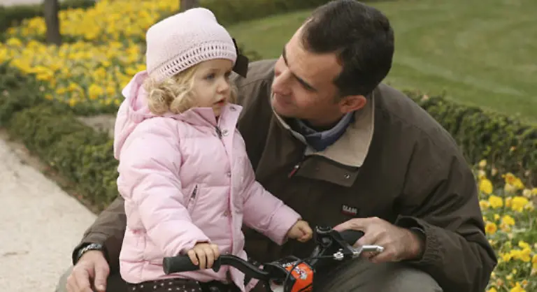 wie-er-seiner-Tochter-Leonor-in-den-Gaerten-seiner-Residenz-unweit-der-Zarzuela-Palastes-das-Fahrradfahren-beibringt