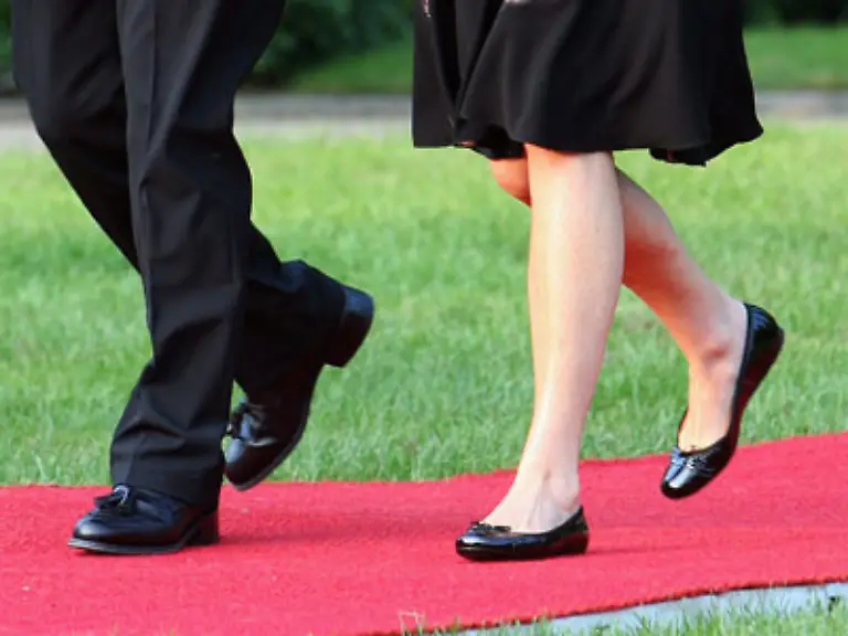 die-uebrigens-genauso-flache-Schuhe-tragen-muss-wie-ihre-Vorgaengerin