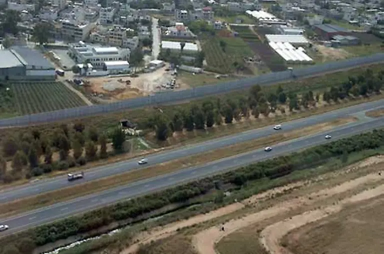 Hart-entlang-der-Grenzlinie-baute-Israel-eine-weitere-Autobahn-Die-haessliche-Mauer-soll-die-Autofahrer-vor-palaestinensischen-Heckenschuetzen-bewahren-Jenseits-der-Mauer-liegt-Kalkilja
