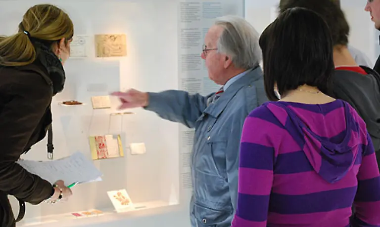 Der-Zeitzeuge-Karel-Hybek-zeigt-Schuelern-aus-Brandenburg-ein-Heft-das-er-waehrend-seiner-Inhaftierung-unter-Lebensgefahr-angefertigt-hat