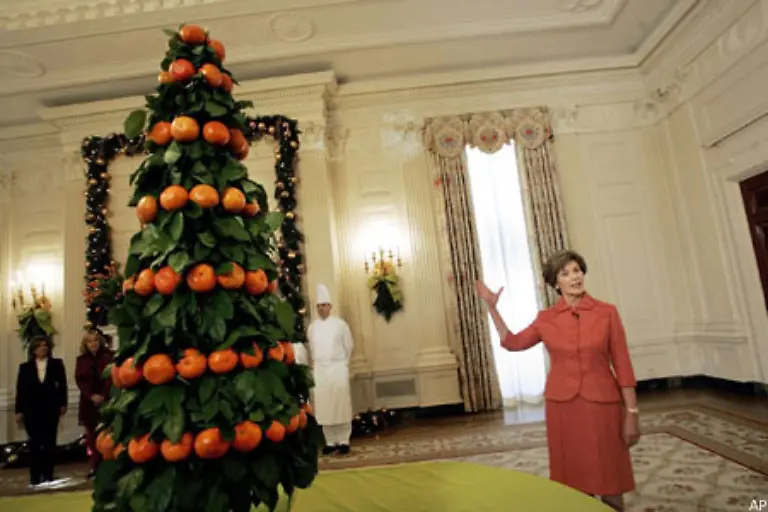 2005-zeigt-Laura-Bush-das-Prunkstueck-des-Weihnachtsschmucks-im-East-Room-des-Weissen-Hauses-Ein-Weihnachtsbaum-aus-Mandarinen-sowie-Blaettern-von-Mandarinen-und-Zitronenbaeumen-Das-Bild-zeigt-Traditionen-koennen-modernisiert-werden