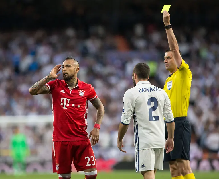 Bayern-Munich-s-midfielder-Arturo-Vidal-receiving-yellow-card-during-the-UEFA-Champions-League-Quarter-Final-Second-Leg-match-between-Real-Madrid-and-Bayern-Munich-played-at-the-Santiago-Bernabeu-Stadium-in-Madrid-on-April-18th-2017-Rudy-SpainDPPI-DPPI