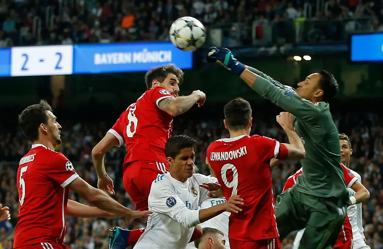 Real-Madrid-s-goalkeeper-Keylor-Navas-right-deflects-a-ball-during-the-Champions-League-semifinal-second-leg-soccer-match-between-Real-Madrid-and-FC-Bayern-Munich-at-the-Santiago-Bernabeu-stadium-in-Madrid-Spain-Tuesday-May-1-2018-Others-in-the-photo-are-from-left-Bayern-s-Mats-Hummels-Bayern-s-Javi-Martinez-and-Bayern-s-Robert-Lewandowski