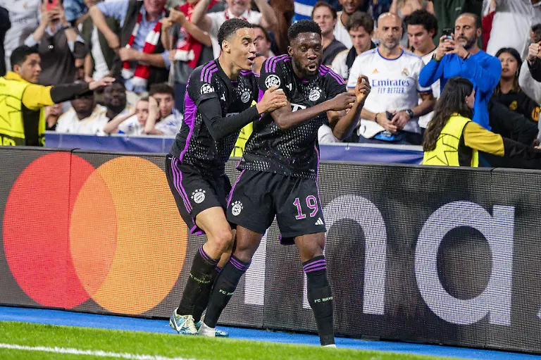 MADRID-SPAIN-MAY-8-Alphonso-Davies-of-FC-Bayern-Munchen-R-seen-celebrating-his-goal-with-Jamal-Musitala-of-FC-Bayern-Munchen-L-during-the-UEFA-Champions-League-semi-final-second-leg-match-between-Real-Madrid-and-FC-Bayern-Munchen-at-Estadio-Santiago-Bernabeu-on-May-8-2024-in-Madrid-Spain