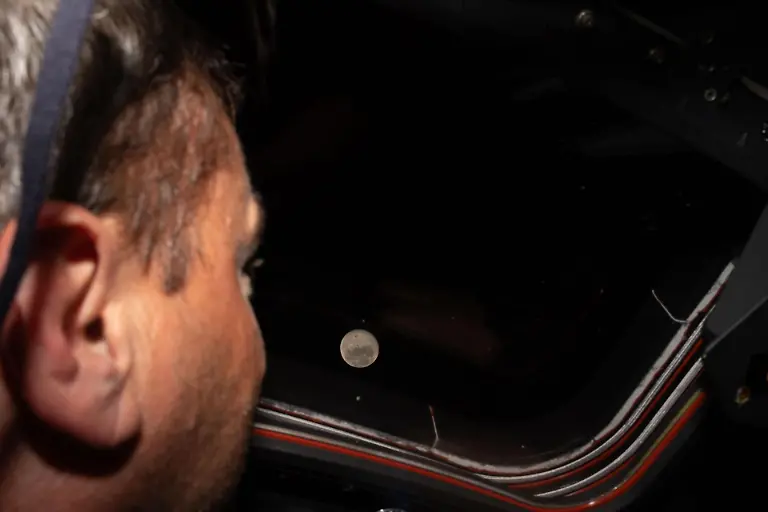 260406-WASHINGTON-April-6-2026-Xinhua-NASA-astronaut-Reid-Wiseman-looks-out-one-of-the-Orion-spacecraft-s-main-cabin-windows-at-the-Moon-on-April-6-2026-The-crew-of-the-Artemis-II-mission-on-Monday-broke-the-record-for-the-farthest-distance-from-Earth-ever-traveled-by-humans-surpassing-the-milestone-achieved-by-Apollo-13-in-April-1970-according-to-NASA