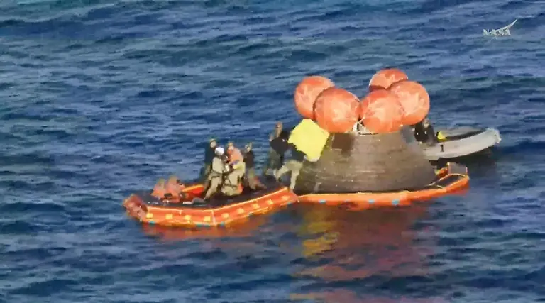 Crew-members-Christina-Koch-Jeremy-Hansen-and-Victor-Glover-are-extracted-from-the-Artemis-II-capsule-by-recovery-personnel-in-the-Pacific-Ocean-in-this-screengrab-from-a-livestream-video-after-the-Artemis-II-crew-s-flyby-of-the-Moon-April-10-2026