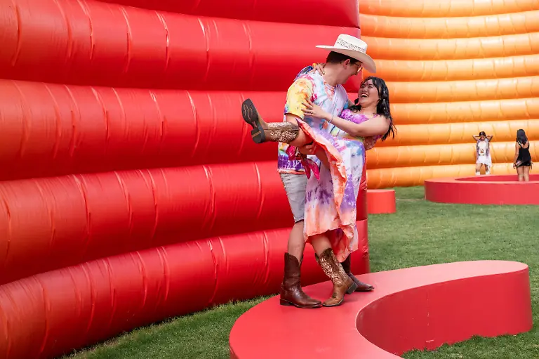 Festivalgoers-Carter-Knight-left-and-Annie-Hua-of-New-York-are-seen-during-the-first-weekend-of-Coachella-Valley-Music-and-Arts-Festival-on-Friday-April-10-2026-in-Indio-Calif