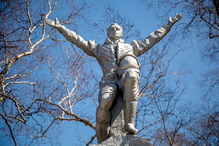 YUZHNO-SAKHALINSK-RUSSIA-APRIL-10-2021-Two-women-hold-hands-as-they-stand-in-front-of-a-monument-to-Russian-pilot-and-cosmonaut-Yuri-Gagarin-first-human-in-space-in-Gagarin-Park-The-60th-anniversary-of-the-first-human-spaceflight-is-celebrated-on-April-12-2021-Soviet-cosmonaut-Yuri-Gagarin-orbited-the-Earth-aboard-the-Vostok-1-spacecraft-on-April-12-1961