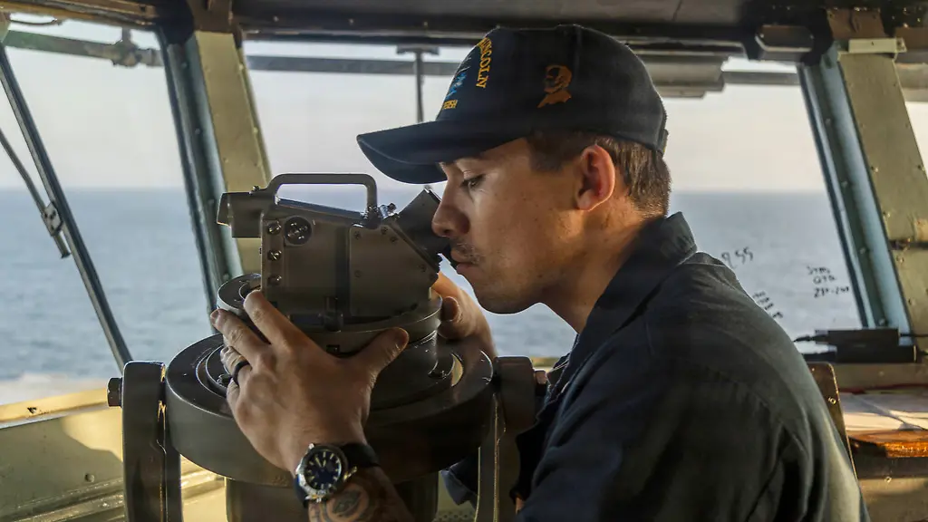 This-image-provided-by-U-S-Central-Command-shows-a-Navy-sailor-standing-watch-on-the-bridge-of-the-USS-Abraham-Lincoln-CVN-72-in-support-of-Operation-Epic-Fury-on-Sunday-March-1-2026-U-S