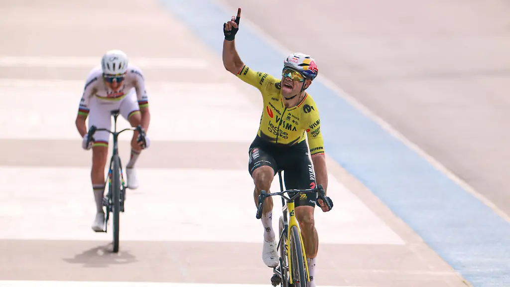 Belgium-s-Wout-van-Aert-crosses-the-finish-line-ahead-of-Tadej-Pogacar-of-Slovenia-left-to-win-the-Paris-Roubaix-cycling-race-in-Roubaix-France-Sunday-April-12-2026-Van-Aert-pointed-his-finger-skywards-to-commemorate-Belgian-cyclist-Michael-Goolaerts-who-died-after-crashing-in-the-race-in-2018