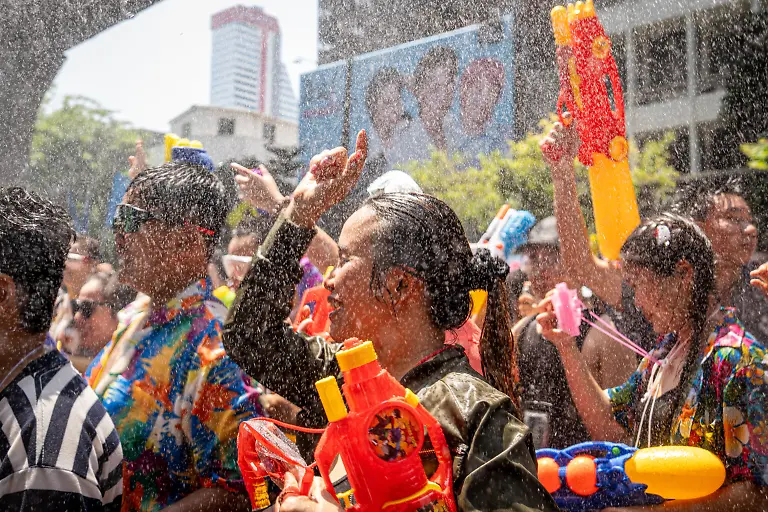 April-12-2026-Bangkok-Thailand-Participants-dance-among-the-crowd-during-the-Songkran-celebrations-The-kickoff-of-Songkran-on-Silom-Road-marks-the-start-of-Thailandas-New-Year-with-one-of-Bangkokas-most-iconic-celebrations-Traditionally-rooted-in-rituals-of-cleansing-and-renewal-the-festival-has-evolved-into-a-vibrant-public-event-where-crowds-gather-for-large-scale-water-fights-Silom-with-its-central-location-and-lively-atmosphere-has-become-a-key-hotspot-drawing-both-locals-and-visitors-into-the-heart-of-the-festivities
