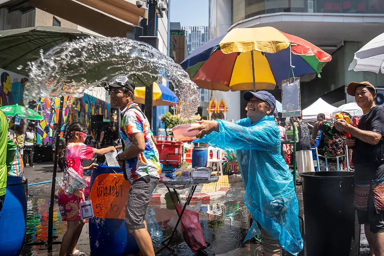 People-throw-water-along-a-street-near-Silom-during-the-Songkran-celebrations-The-kickoff-of-Songkran-on-Silom-Road-marks-the-start-of-Thailands-New-Year-with-one-of-Bangkoks-most-iconic-celebrations-Traditionally-rooted-in-rituals-of-cleansing-and-renewal-the-festival-has-evolved-into-a-vibrant-public-event-where-crowds-gather-for-large-scale-water-fights-Silom-with-its-central-location-and-lively-atmosphere-has-become-a-key-hotspot-drawing-both-locals-and-visitors-into-the-heart-of-the-festivities