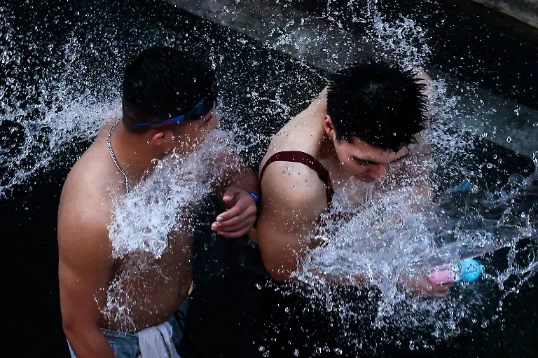 Revellers-play-with-water-as-they-celebrate-the-Songkran-holiday-which-marks-the-Thai-New-Year-in-Bangkok-Thailand-April-12-2026