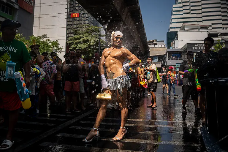 April-12-2026-Bangkok-Thailand-A-reveler-performs-on-the-streets-during-the-Songkran-celebrations-The-kickoff-of-Songkran-on-Silom-Road-marks-the-start-of-Thailandas-New-Year-with-one-of-Bangkokas-most-iconic-celebrations-Traditionally-rooted-in-rituals-of-cleansing-and-renewal-the-festival-has-evolved-into-a-vibrant-public-event-where-crowds-gather-for-large-scale-water-fights-Silom-with-its-central-location-and-lively-atmosphere-has-become-a-key-hotspot-drawing-both-locals-and-visitors-into-the-heart-of-the-festivities