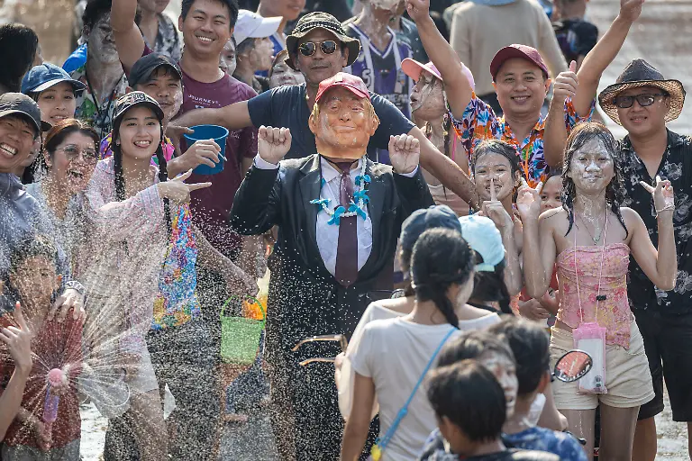 A-participant-wears-a-mask-of-U-S-President-Donald-Trump-during-the-Songkran-water-festival-to-celebrate-the-Thai-New-Year-in-Prachinburi-province-Thailand-Monday-April-13-2026