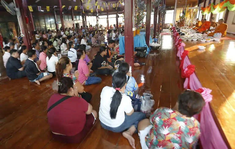 People-pray-to-celebrate-ahead-of-the-Songkran-festival-at-a-temple-in-Nakhon-Sawan-province-north-of-Bangkok-on-April-13-2026