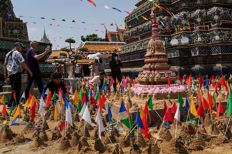 People-build-stupas-with-sand-to-mark-the-annual-Songkran-festival-the-traditional-Thai-New-Year-celebrations-at-Wat-Pho-temple-also-known-as-the-Temple-of-the-Reclining-Buddha-in-Bangkok-Thailand-on-April-12-2026