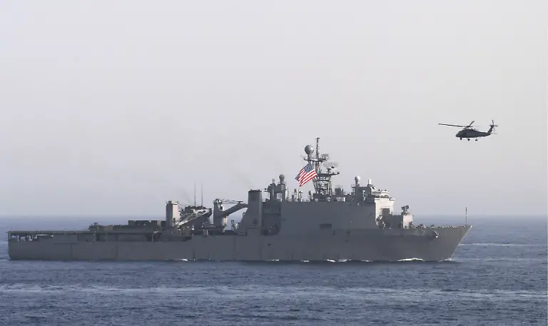 epa01017344-US-Navy-handout-picture-dated-22-May-2007-shows-Dock-landing-ship-USS-Rushmore-LSD-47-on-transit-through-the-Gulf-of-Oman-while-an-SH-60H-Seahawk-from-the-Eightballers-of-Helicopter-Anti-Submarine-Squadron-HS-8-moves-into-position-to-capture-imagery-during-a-photo-exercise-Rushmore-as-part-of-Bonhomme-Richard-Expeditionary-Strike-Group-is-on-a-scheduled-deployment-in-support-of-maritime-security-operations-The-USS-John-C-Stennis-and-USS-Nimitz-aircraft-carriers-and-their-strike-groups-entered-Gulf-waters-to-support-troops-in-Iraq-and-conduct-training-exercises-the-US-Navy-said-on-23-May-2007