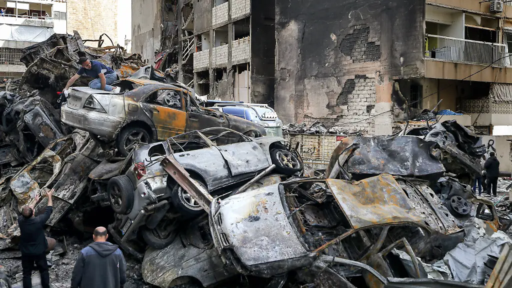 April-14-2026-Beirut-Lebanon-People-salvage-belongings-from-their-destroyed-cars-piled-on-top-of-dozens-of-other-burned-vehicles-at-the-site-of-an-Israeli-air-strike-in-Beirut-Lebanon-and-Israel-are-holding-their-first-direct-diplomatic-talks-in-more-than-30-years-The-talks-are-aimed-at-preparing-negotiations-to-resolve-Israel-s-conflict-with-pro-Iranian-Hezbollah-Hezbollah-leader-Naim-Qassem-urged-Lebanon-to-cancel-the-planned-meeting-with-Israel-reiterating-his-group-s-rejection-of-direct-negotiations-with-its-foe