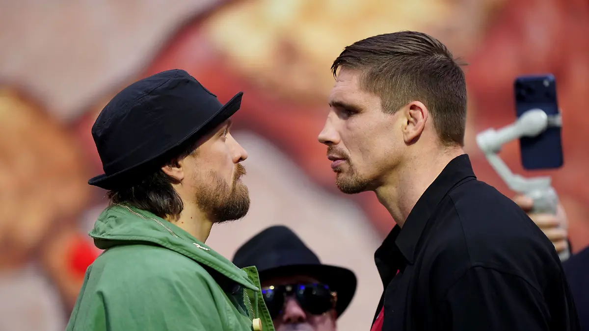 Boxers-Oleksandr-Usyk-left-the-WBC-heavyweight-champion-and-challenger-Rico-Verhoeven-face-off-during-a-press-conference-in-London-Tuesday-April-14-2026