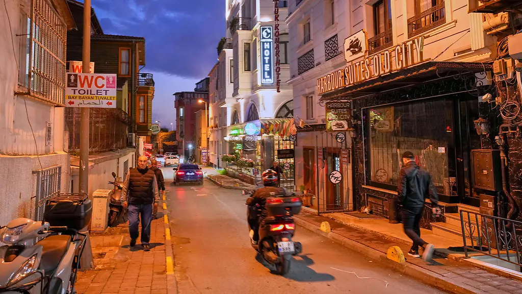 People-walk-past-the-Harbour-Suites-Old-City-hotel-in-Istanbul-Turkey-Monday-Nov-24-2025