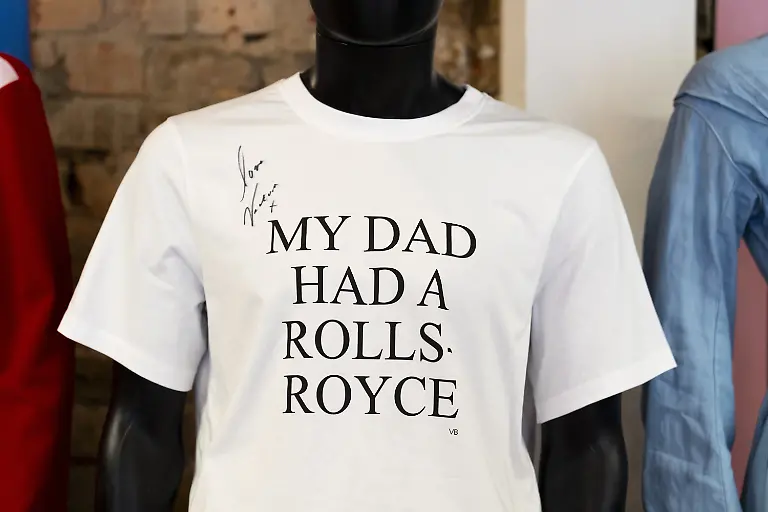 Netflix-shop-The-Rolls-Royce-t-shirt-from-Beckham-signed-by-Victoria-Beckham-during-a-preview-of-the-Netflix-wardrobe-and-prop-pop-up-store-As-Seen-on-Netflix-which-features-wardrobe-props-and-memorabilia-from-some-of-Netflix-s-most-popular-shows-on-Bethnal-Green-Road-in-east-London-A-suit-worn-by-Gillian-Anderson-while-playing-Margaret-Thatcher-in-The-Crown-Robbie-Williams-Versace-pants-and-a-signed-David-Beckham-Real-Madrid-shirt-are-among-the-items-going-on-sale-at-the-pop-up-shop-and-online-auction-Picture-date-Thursday-October-10-2024-The-pop-up-opens-to-the-public-for-one-day-on-October-12-before-moving-to-the-Bullring-in-Birmingham-for-one-day-on-the-October-19-alongside-an-online-auction-with-all-proceeds-going-to-mental-health-charity-Mind