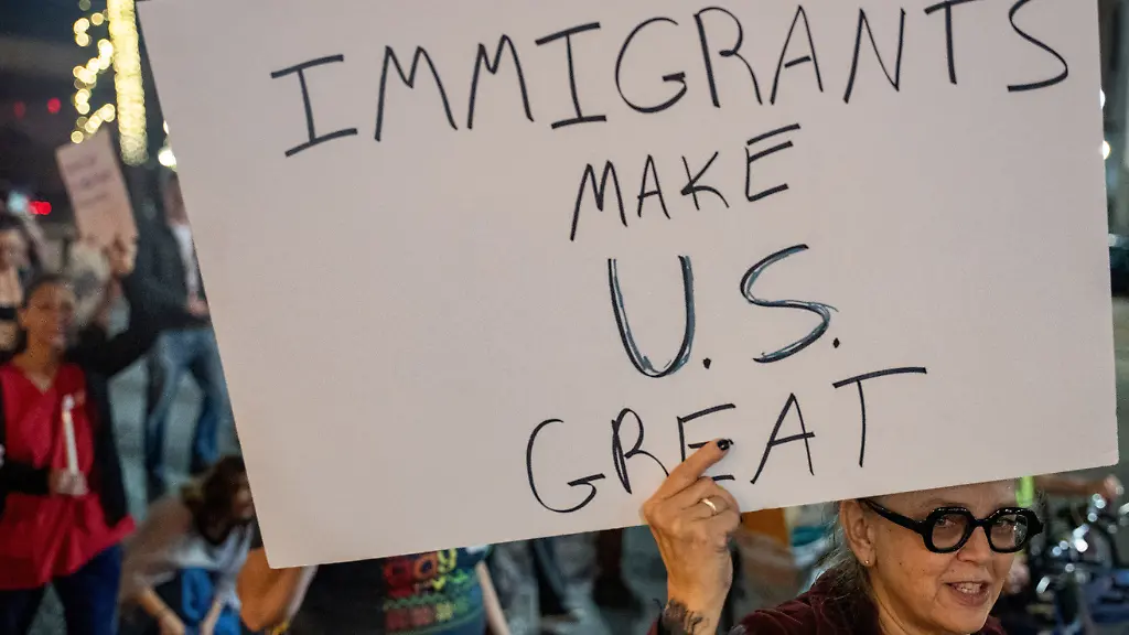 A-woman-holds-a-poster-as-immigrants-rights-activists-stage-a-traditional-Mexican-posada-reenacting-Mary-and-Joseph-s-search-for-shelter-to-symbolise-immigrants-seeking-refuge-from-Immigration-and-Customs-Enforcement-ICE-agents-during-the-ongoing-immigration-operation-Catahoula-Crunch-in-New-Orleans-Louisiana-U-S-December-18-2025