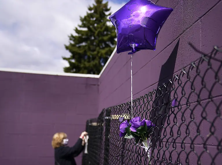 April-21-2021-Chanhassen-MN-USA-During-the-5th-anniversary-of-Prince-s-death-fans-were-invited-into-Paisley-Park-20-at-a-time-to-pay-respect-to-Minnesota-s-legendary-musician-and-artist-Here-a-balloon-floats-in-the-breeze-on-a-remembrance-fence-as-Diane-Maus-of-Lino-Lakes-put-up-a-poem-she-wrote-to-Prince-called-Tribute-To-An-Icons-outside-the-museum-Wednesday-in-Chanhassen