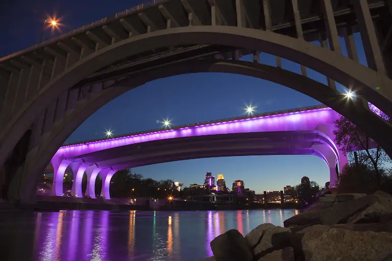 MINNEAPOLIS-MINNESOTA-USA-APRIL-22-2016-The-I-35W-bridge-over-the-Mississippi-River-in-Minneapolis-is-lit-with-purple-lights-in-honor-of-the-passing-of-music-legend-Prince
