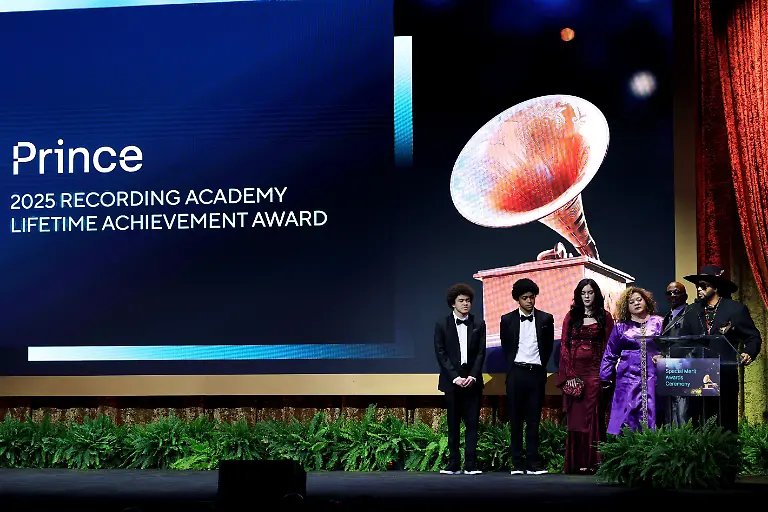 LOS-ANGELES-CALIFORNIA-FEBRUARY-01-Andre-Cymone-R-accepts-the-2025-Recording-Academy-Lifetime-Achievement-Award-on-behalf-of-Prince-with-Nicholas-Nelson-Marcus-Nelson-Cherith-Nelson-Breanna-Nelson-and-Jerome-Benton-onstage-at-the-Special-Merit-Awards-Ceremony-and-Nominees-Reception-during-the-67th-Annual-GRAMMY-Awards-on-February-01-2025-in-Los-Angeles-California