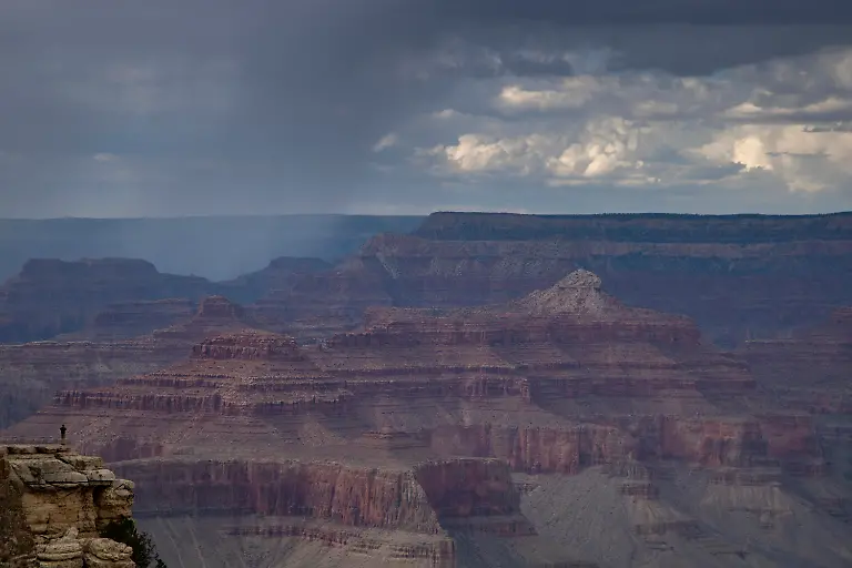 Landscape-showing-Gran-Canyon-with-a-person-over-a-cliff-in-Arizona-USA