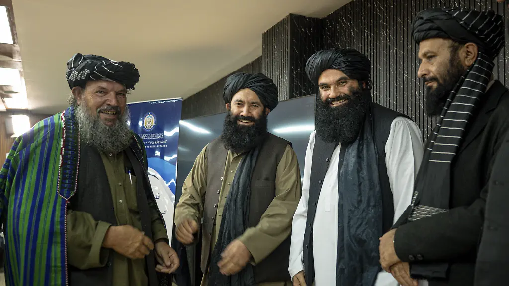 From-right-to-left-Mawlawi-Hamdullah-Naumani-Minister-of-Communications-and-Information-Technology-Sirajuddin-Haqqani-the-Talibans-acting-Interior-Minister-Mullah-Mohammad-Younis-Akhundzada-Minister-of-Rural-Rehabilitation-and-Development-and-another-Taliban-official-stand-on-a-stage-During-a-ceremony-in-Kabul-Afghanistan-on-December-28-2025-The-ceremony-honors-Kabul-Mayor-Mawlawi-Abdul-Rashid-Baluch-for-his-work-on-urban-development-projects-in-the-capital-Organized-by-the-Talibans-acting-Interior-Minister-Sirajuddin-Haqqani-the-event-is-attended-by-several-senior-officials-and-cabinet-members-Baluch-is-awarded-a-certificate-of-appreciation-and-a-traditional-Afghan-turban-is-placed-on-his-head-as-a-symbolic-gesture-of-respect-at-the-conclusion-of-the-ceremony