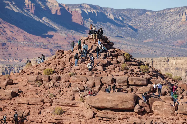 Besucher-klettern-auf-eine-Felsformation-ueber-dem-Canyon-am-Guano-Point-im-Grand-Canyon-West-in-der-Naehe-von-Peach-Springs-Arizona-Visitors-climb-on-rock-formation-rising-above-the-canyon-at-Guano-Point-in-Grand-Canyon-West-near-Peach-Springs-Arizona-Copyright-imageBROKER-RonxBuskirk-iblbus13962408