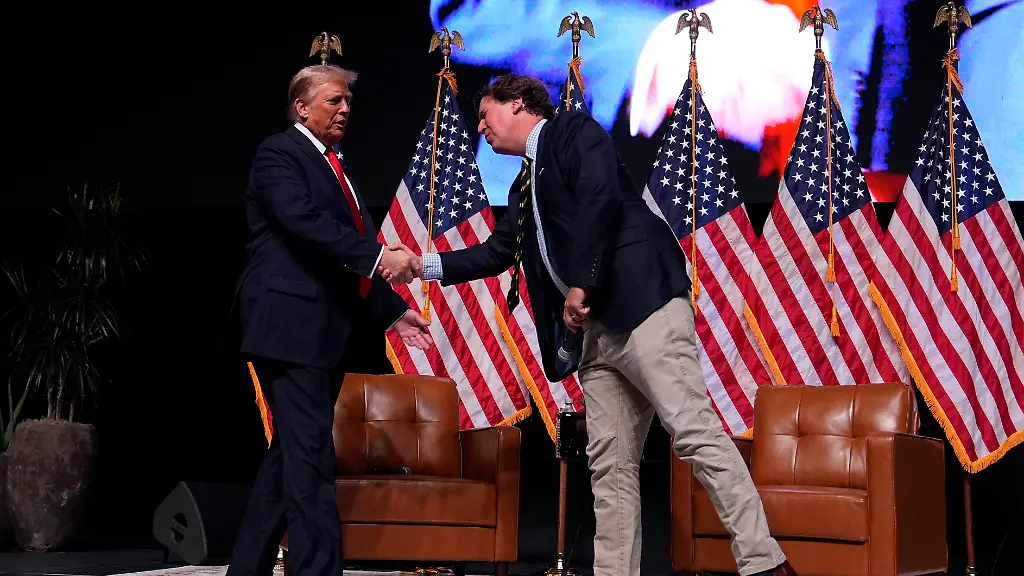 Republican-presidential-nominee-former-President-Donald-Trump-speaks-with-Tucker-Carlson-during-a-Tucker-Carlson-Live-Tour-show-at-Desert-Diamond-Arena-Thursday-Oct-31-2024-in-Glendale-Ariz