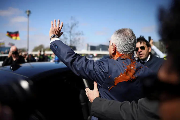 Reza-Pahlavi-the-exiled-son-of-Iran-s-last-shah-and-an-Iranian-opposition-figure-stained-with-red-substance-leaves-after-a-press-conference-at-the-House-of-the-Bundespressekonferenz-in-Berlin-Germany-April-23-2026