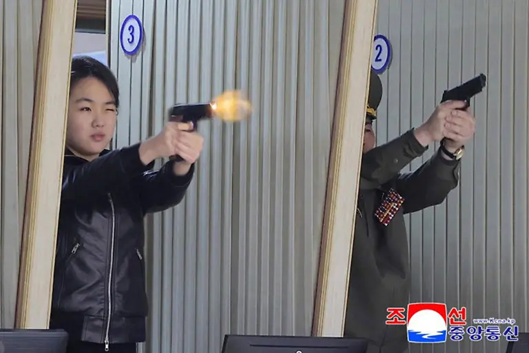 This-image-released-on-March-12-2026-by-the-North-Korean-Official-News-Service-KCNA-shows-North-Korean-leader-Kim-Jong-Un-and-his-daughter-Kim-Ju-Ae-visiting-a-munitions-factory-The-father-daughter-duo-toured-the-facility-before-test-firing-pistols