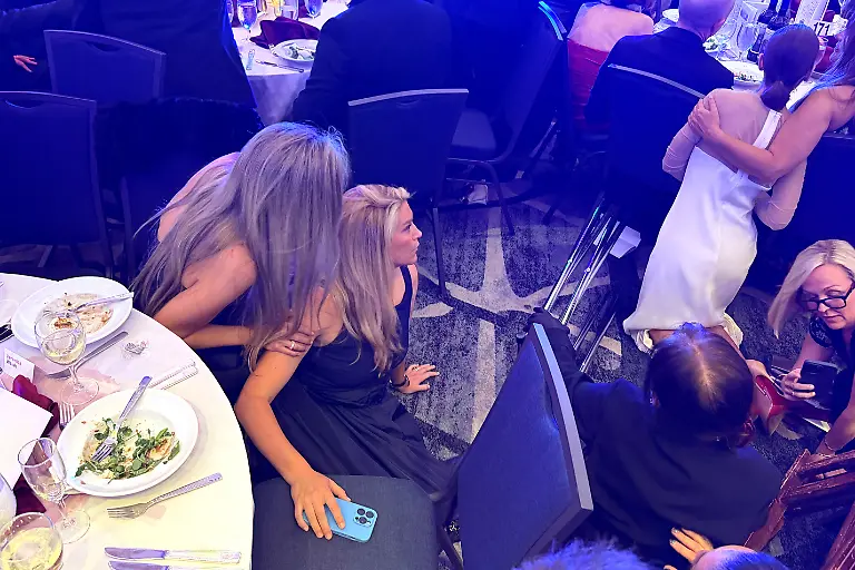 Guests-take-cover-after-U-S-President-Donald-Trump-and-first-lady-Melania-Trump-were-rushed-out-of-the-White-House-Correspondents-Association-dinner-by-Secret-Service-agents-after-a-loud-unidentified-noise-in-Washington-D-C-U-S-April-25-2026-Picture-taken-using-a-mobile-phone