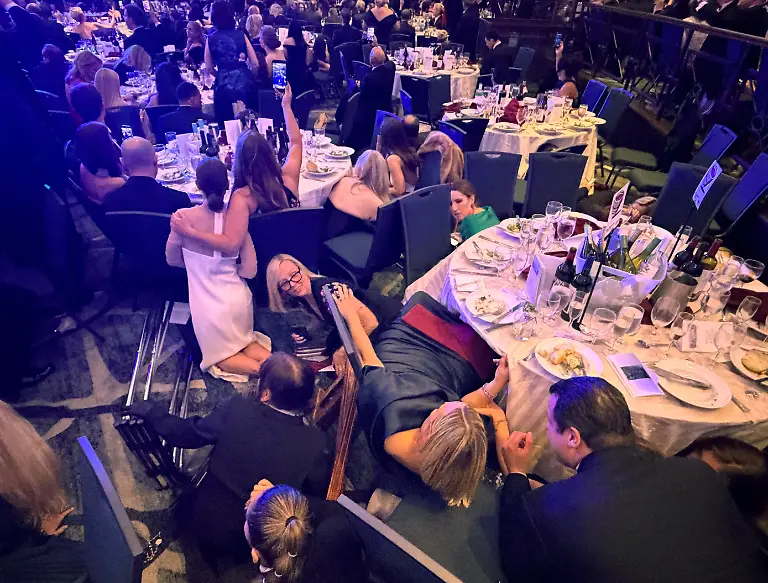 Guests-take-cover-after-U-S-President-Donald-Trump-and-first-lady-Melania-Trump-were-rushed-out-of-the-White-House-Correspondents-Association-dinner-by-Secret-Service-agents-after-a-loud-unidentified-noise-in-Washington-D-C-U-S-April-25-2026-Picture-taken-using-a-mobile-phone