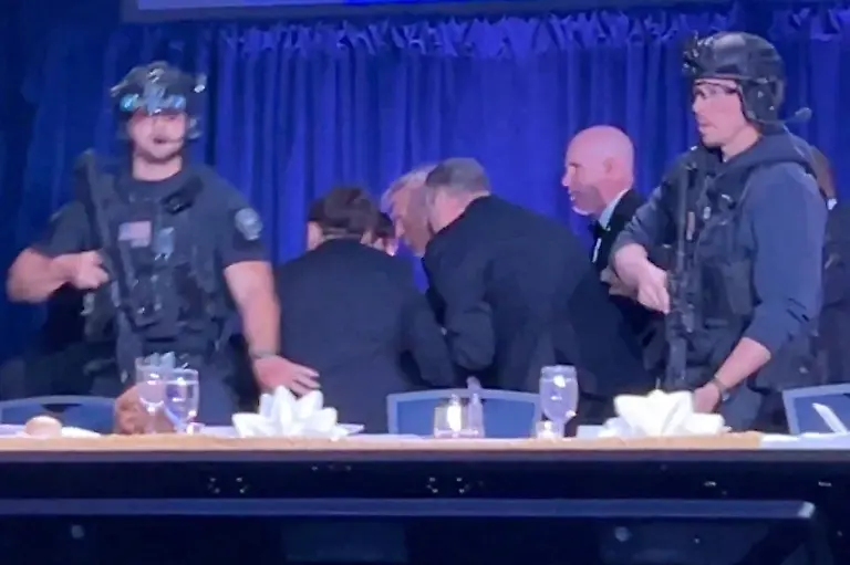 U-S-President-Donald-Trump-is-escorted-out-as-a-shooter-opens-fire-during-the-annual-White-House-Correspondents-Association-dinner-in-Washington-D-C-U-S-April-25-2026-in-this-screen-capture-from-video-REUTERS-Bo-Erickson-THIS-IMAGE-WAS-PROCESSED-BY-REUTERS-TO-ENHANCE-QUALITY-AN-UNPROCESSED-VERSION-HAS-BEEN-PROVIDED-SEPARATELY